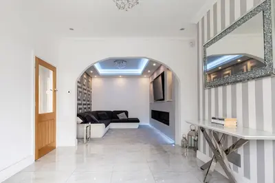 a living room with a couch and a mirror at Lux nights away in Cleveleys