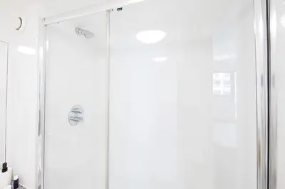 a shower with a glass door in a bathroom at Prospect Point in Liverpool in Liverpool