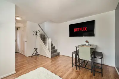 a living room with a table and a exit sign on the wall at The Acorn Nook - Central Stay in Liverpool