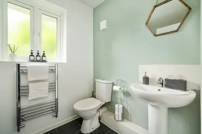 a white bathroom with a toilet and a sink at The Acorn Nook - Central Stay in Liverpool