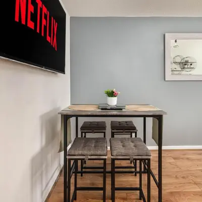 a table with four stools in a room at The Acorn Nook - Central Stay in Liverpool