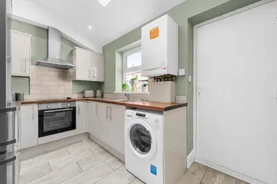 a kitchen with a washer and dryer at Bolton Retreat Modern 3BR Home Pool Table & Parking Sleeps 6 in Bolton