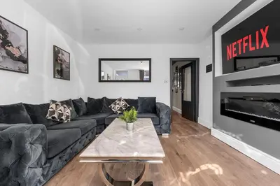 a living room with a couch and a table at Bolton Retreat Modern 3BR Home Pool Table & Parking Sleeps 6 in Bolton