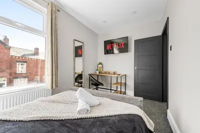 a bedroom with a bed and a window at Bolton Retreat Modern 3BR Home Pool Table & Parking Sleeps 6 in Bolton