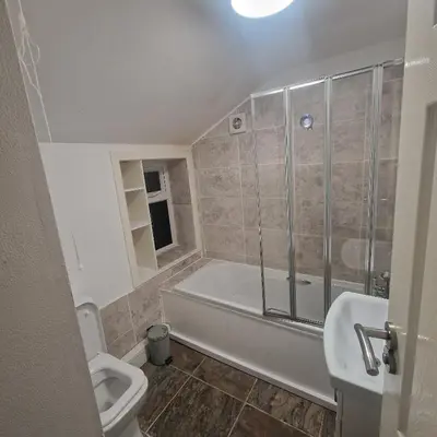 a bathroom with a tub and a toilet and a sink at Ground Floor Holiday flat in Blackpool
