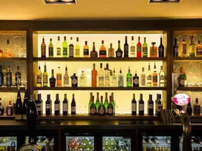 a bar filled with lots of bottles of alcohol at Derby Arms in Longridge