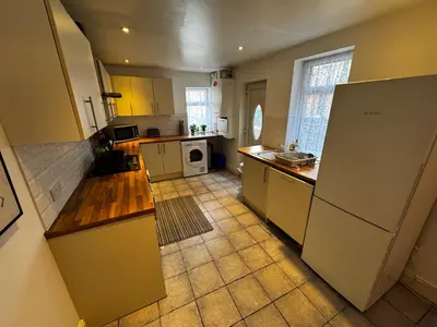 a kitchen with white appliances and a tile floor at Harmony House - Close to Blackpool FC - Excellent Transport Links - Sleeps up to 6 in Blackpool