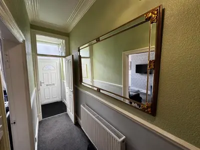 a hallway with a large mirror on the wall at Harmony House - Close to Blackpool FC - Excellent Transport Links - Sleeps up to 6 in Blackpool