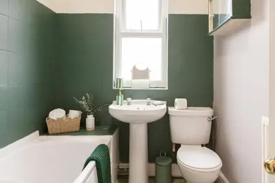 a bathroom with a toilet and a sink and a tub at CLOSe in Liverpool