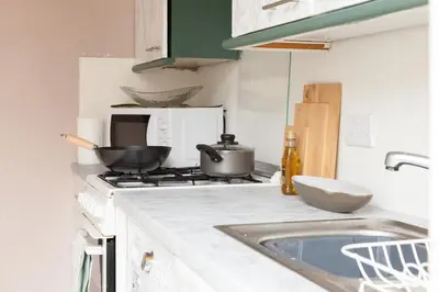 a kitchen with a stove with pots and pans on it at CLOSe in Liverpool