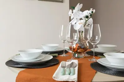 a table with plates and bowls and wine glasses at CLOSe in Liverpool