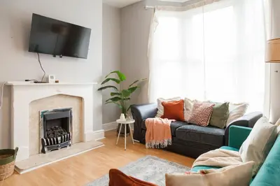 a living room with a couch and a fireplace at CLOSe in Liverpool