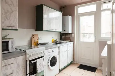 a kitchen with a washing machine and a washer at CLOSe in Liverpool