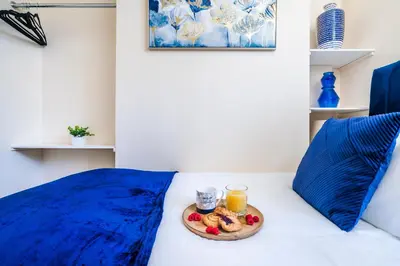 a tray of fruit and drinks on a bed at Long-Term Work Stay 20 Percent OFF Fully Equipped & Central Location in Horwich