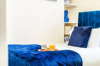 a tray of food and a drink on a bed at Long-Term Work Stay 20 Percent OFF Fully Equipped & Central Location in Horwich
