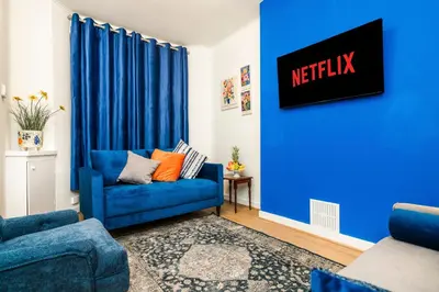 a blue couch in a living room with a blue wall at Long-Term Work Stay 20 Percent OFF Fully Equipped & Central Location in Horwich