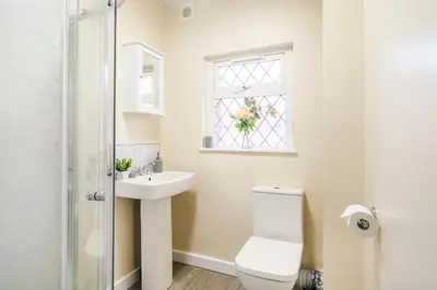 a bathroom with a toilet and a sink and a window at Long-Term Work Stay 20 Percent OFF Fully Equipped & Central Location in Horwich