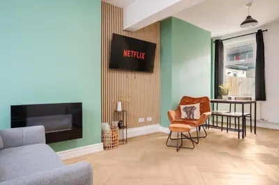 a living room with a couch and a chair at 10 Min to Beach Cheap Taxi to City FreeParking in Liverpool