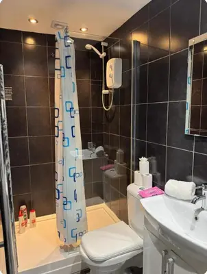 a bathroom with a shower and a toilet and a sink at Room 3 Shared House in L6 in Liverpool