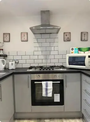 a kitchen with a stove and a microwave at Room 3 Shared House in L6 in Liverpool