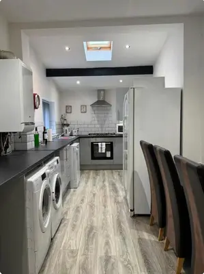 a kitchen with a washer and dryer in it at Room 3 Shared House in L6 in Liverpool