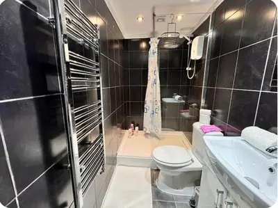 a bathroom with a toilet and a shower and a sink at Room 3 Shared House in L6 in Liverpool