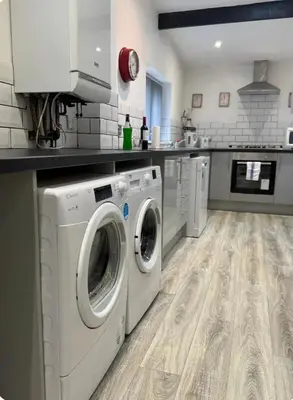 a kitchen with a washer and dryer in it at Room 3 Shared House in L6 in Liverpool