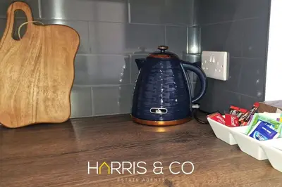 a blue tea kettle sitting on top of a counter at The Poulton Paradise in Poulton le Fylde