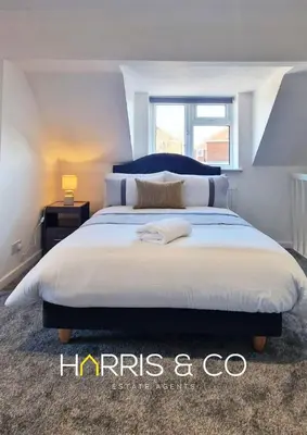 a bedroom with a large bed with a window at The Poulton Paradise in Poulton le Fylde