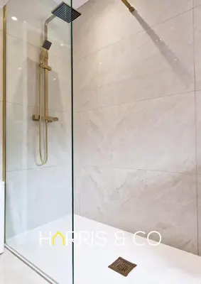 a shower with a glass door in a bathroom at The Poulton Paradise in Poulton le Fylde