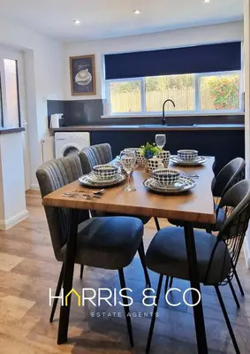 a dining room table with chairs and a dining room at The Poulton Paradise in Poulton le Fylde