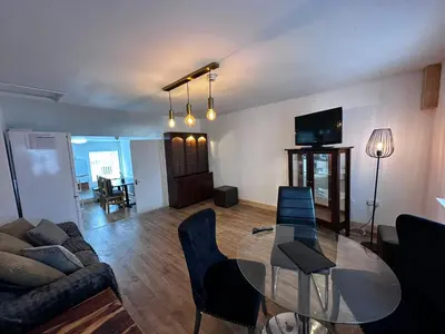a living room with a glass table and a couch at Cottage style flat in Oswaldtwistle