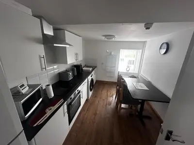 a kitchen with a counter and a table in it at Cottage style flat in Oswaldtwistle