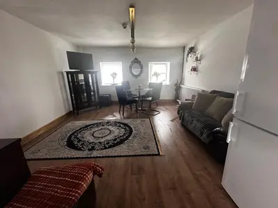a living room with a couch and a table at Cottage style flat in Oswaldtwistle