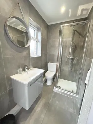 a bathroom with a sink and a shower and a toilet at Lytham House Retreat - Free Parking in Marton