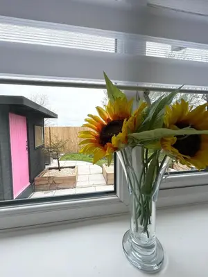 a vase filled with yellow flowers sitting in a window at Lytham House Retreat - Free Parking in Marton