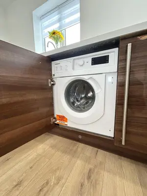 a washing machine in a laundry room with a window at Lytham House Retreat - Free Parking in Marton