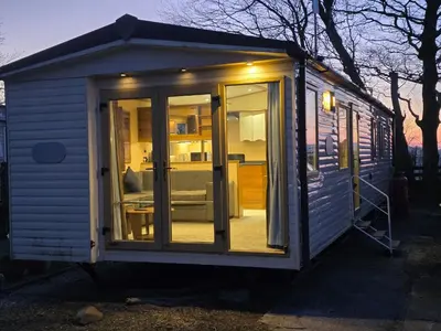 a tiny house with a sliding glass door at Duck Creek at Beacon Fell View in Longridge