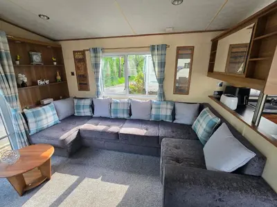 a living room with a couch and a window at Duck Creek at Beacon Fell View in Longridge