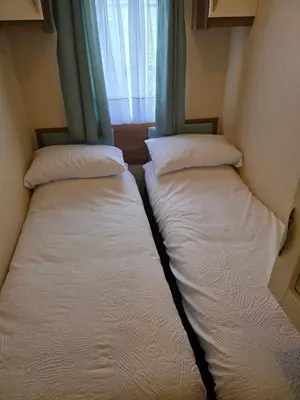 two beds in a small room with a window at Duck Creek at Beacon Fell View in Longridge