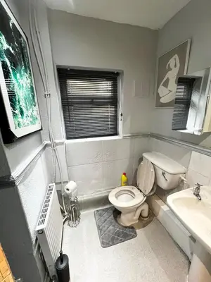 a bathroom with a toilet and a sink at Cozy & Stylish 3-Bed house Parking & 3 Smart TVs in Liverpool