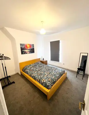 a bedroom with a bed in a room at Cute two bedroom house with free street parking in Liverpool