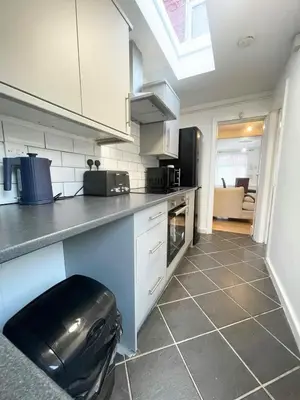 a kitchen with a sink and a counter top at Cute two bedroom house with free street parking in Liverpool