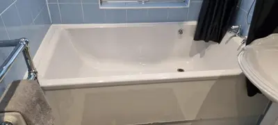 a white bath tub in a bathroom with a sink at Beautiful Residential Within Easy Reach of Town in Haydock