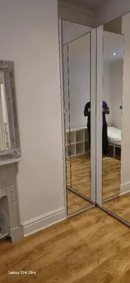a mirrored door in a room with a bedroom at Beautiful Residential Within Easy Reach of Town in Haydock