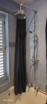 a shower with a black shower curtain in a bathroom at Beautiful Residential Within Easy Reach of Town in Haydock