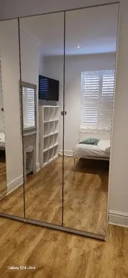 a mirror in a room with a bed and a couch at Beautiful Residential Within Easy Reach of Town in Haydock