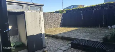 a backyard with a fence and a door in a yard at Beautiful Residential Within Easy Reach of Town in Haydock
