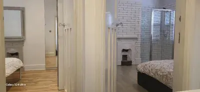 a bedroom with a fireplace and a bed in a room at Beautiful Residential Within Easy Reach of Town in Haydock