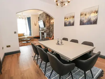 a dining room with a table and chairs at The Alhambra in Southport